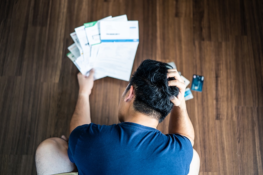 Stressed young man in debt